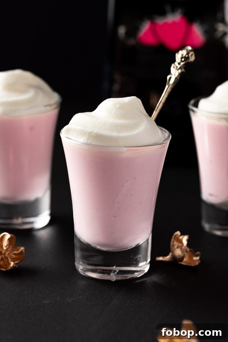 Tequila rose pudding shots topped with whipped cream.