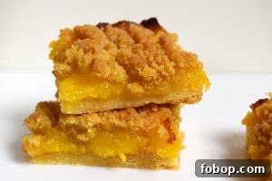 Lemon Curd Shortbread Crumble Bars 2 Lemon curd crumble slice on white background.