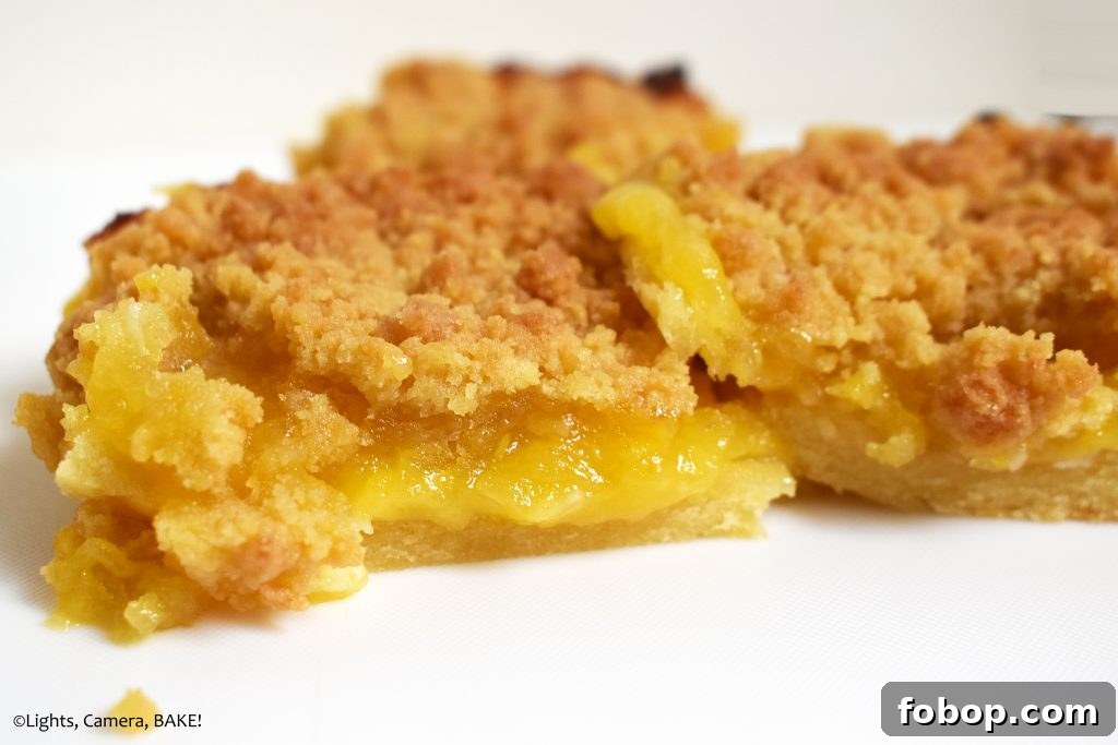 Lemon Curd Shortbread Crumble Bars 3 Lemon curd slice on a white background.