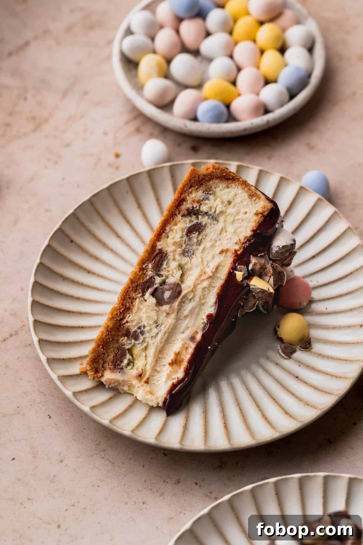 Easter Egg Cheesecake Recipe with Decorative Candy Topping 13 One slice of Easter egg cheesecake on it's side on a plate.