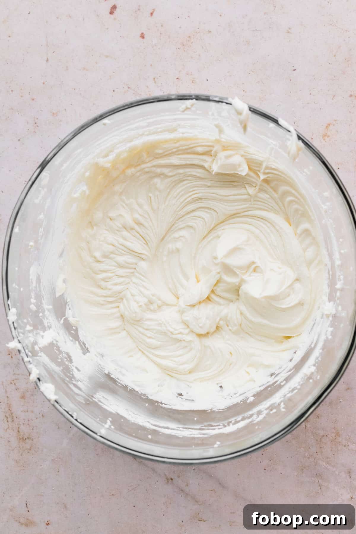 Easter Egg Cheesecake Recipe with Decorative Candy Topping 7 Cream cheese and sugar beaten in a glass bowl.