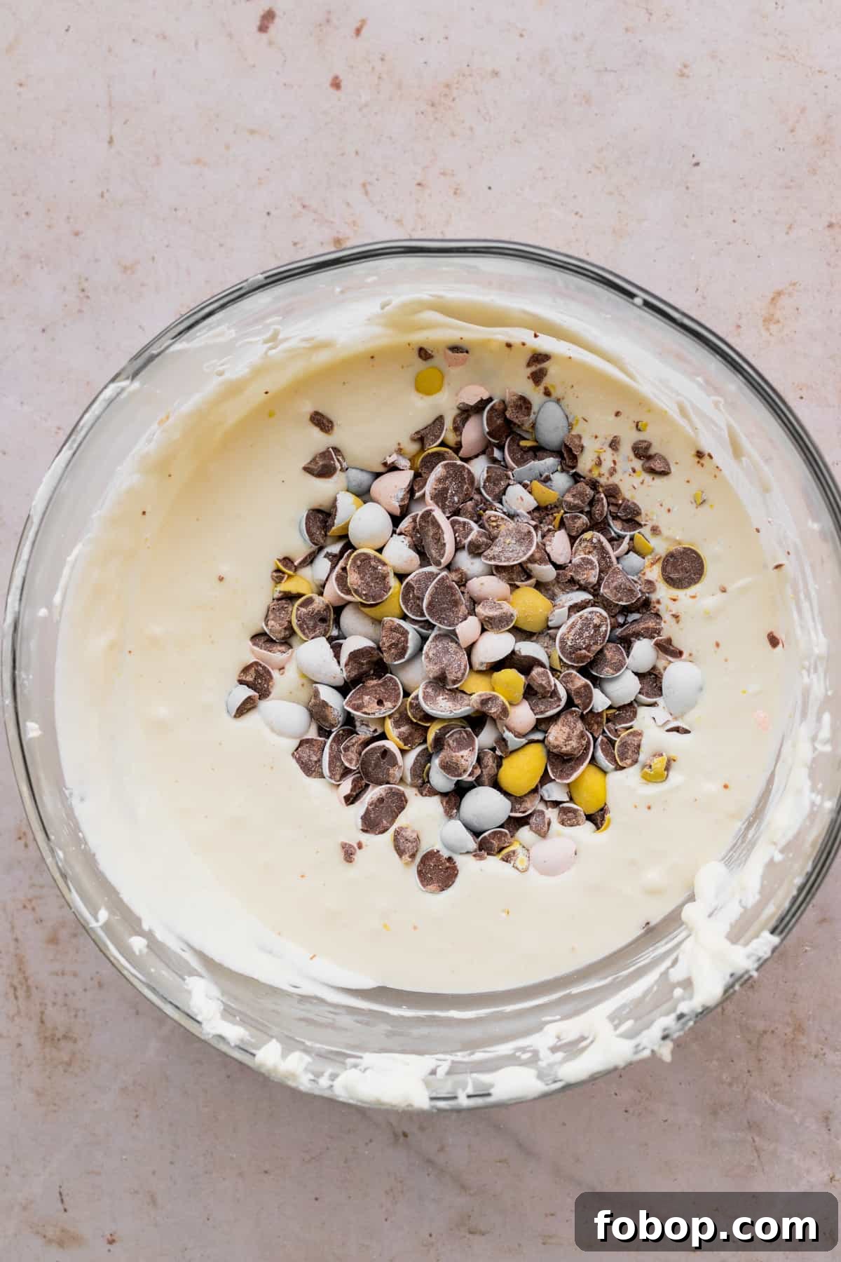Easter Egg Cheesecake Recipe with Decorative Candy Topping 8 Cheesecake batter with chopped mini eggs on top.