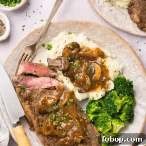 Instant Pot Steak in Rich Homemade Beef Gravy 12 Instant Pot Steak with homemade gluten free gravy on a plate with mashed potatoes and broccoli