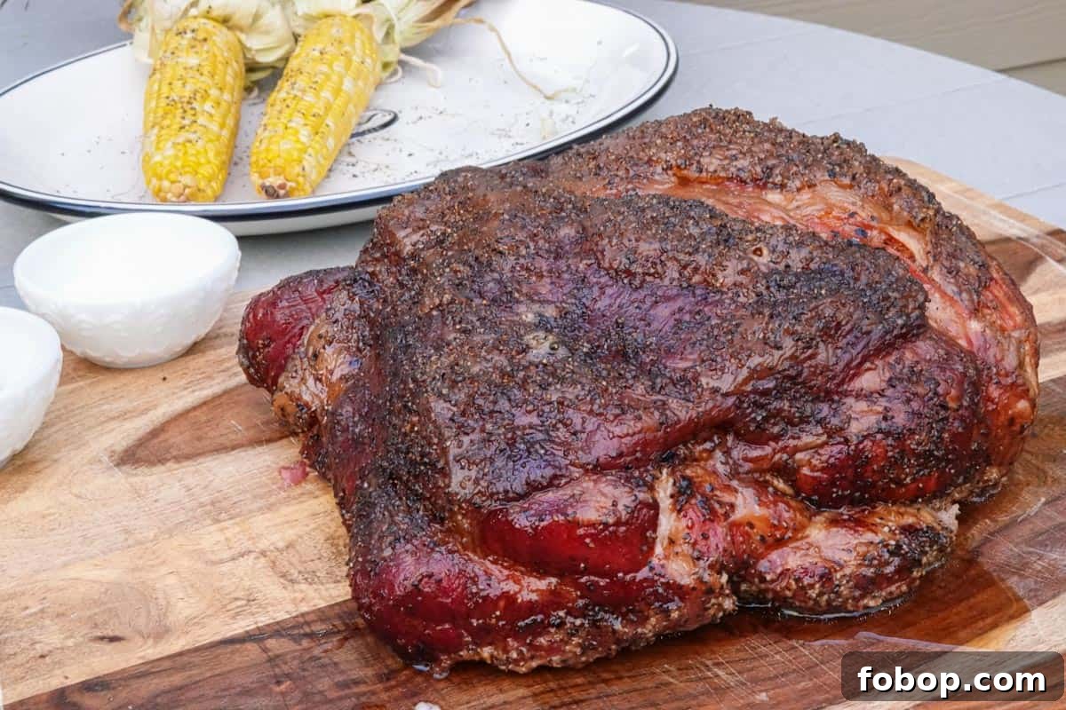 Smoked Pulled Pork Tacos with Tangy Pineapple Slaw 4 smoked pork butt on cutting board with corn in background