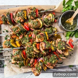 Salmon kebabs slathered in chimichurri on a serving platter.
