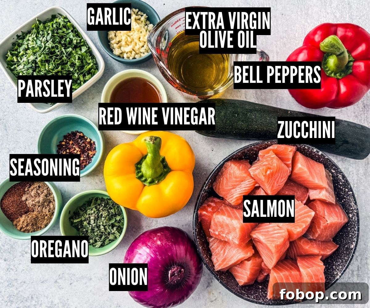 Fresh vegetables, herbs, salmon, and other ingredients on a light background.