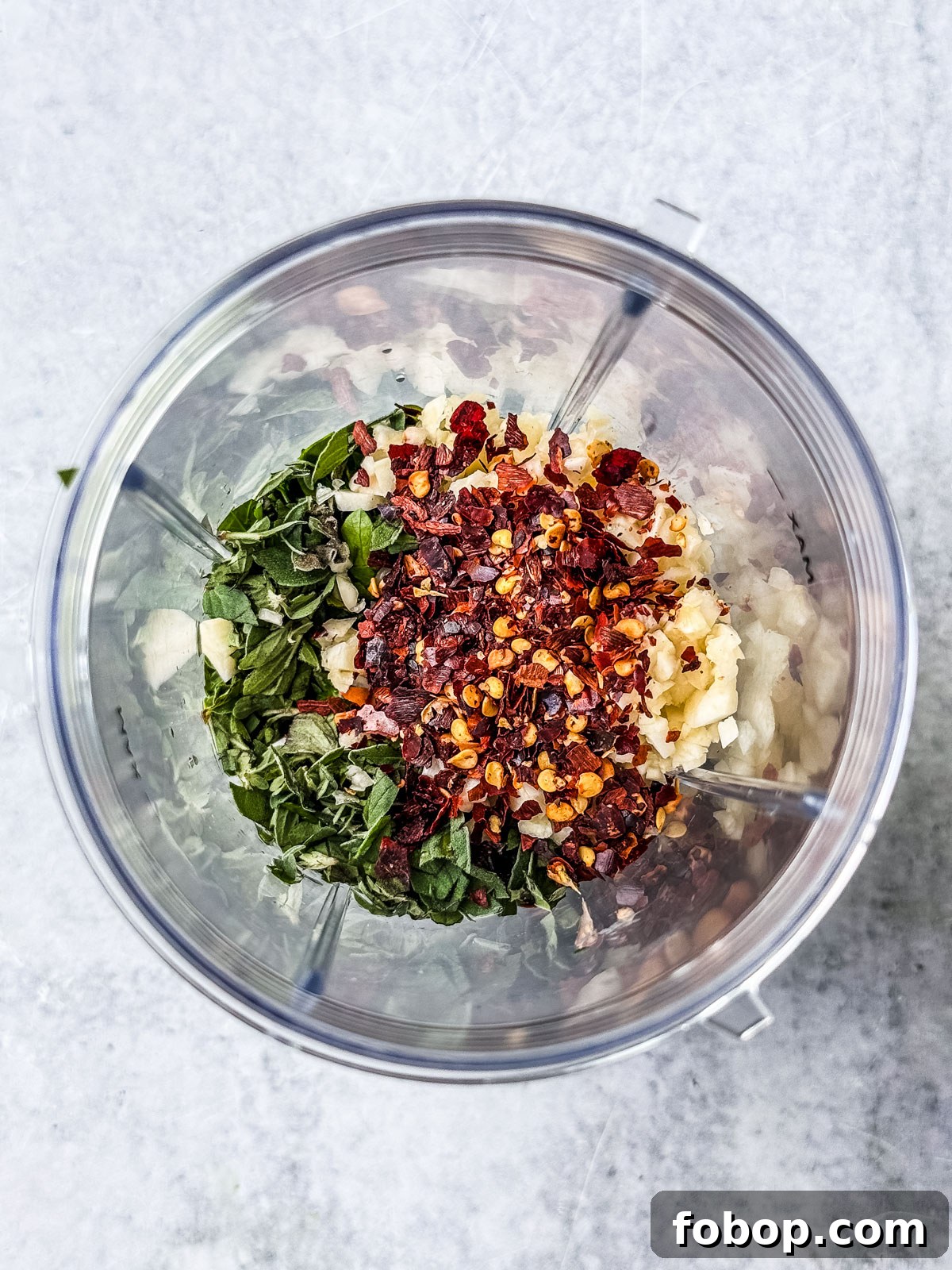 Chimichurri ingredients in a small bullet blender.