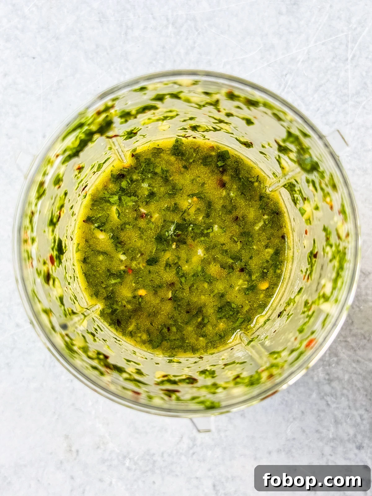 Blended chimichurri in a small bullet blender.