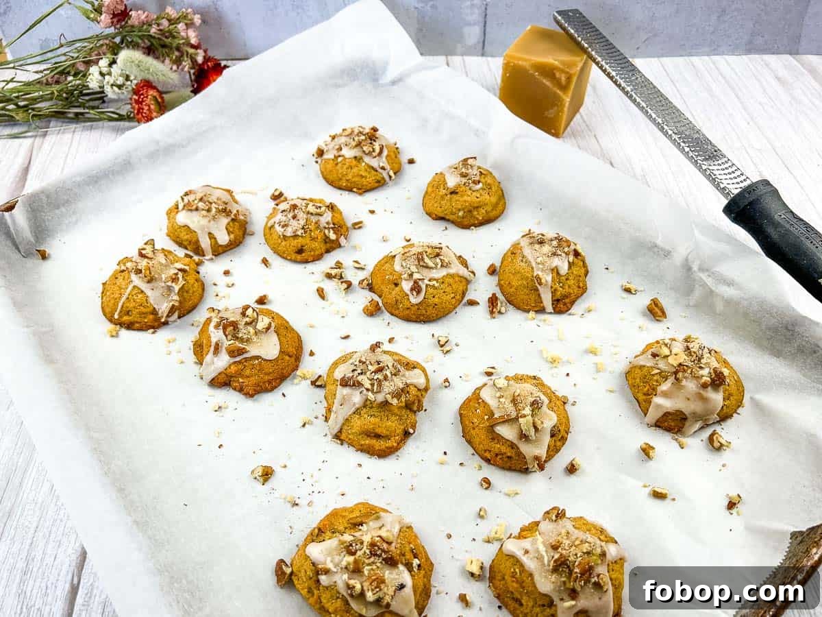 25 Office Cookies Everyone Brings and Raves About 14 Sweet Potato Cookies on a baking sheet with icing and nuts.