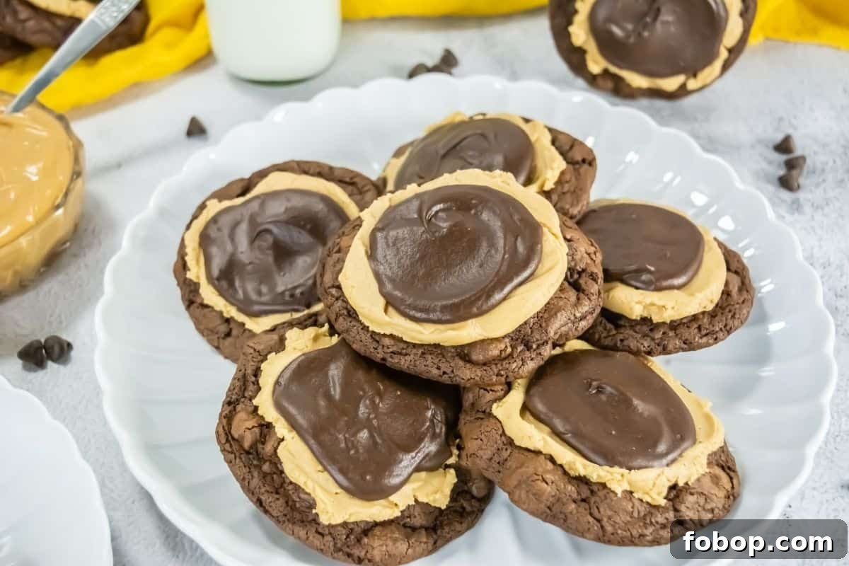 25 Office Cookies Everyone Brings and Raves About 25 A white plate holds several chocolate cookies topped with a layer of peanut butter and a swirl of chocolate frosting.