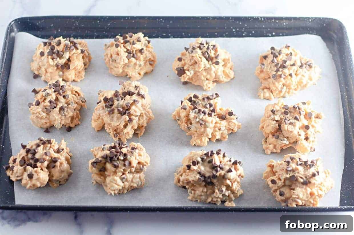 25 Office Cookies Everyone Brings and Raves About 10 A baking tray lined with parchment paper holds twelve Avalanche Crunch Cookies.