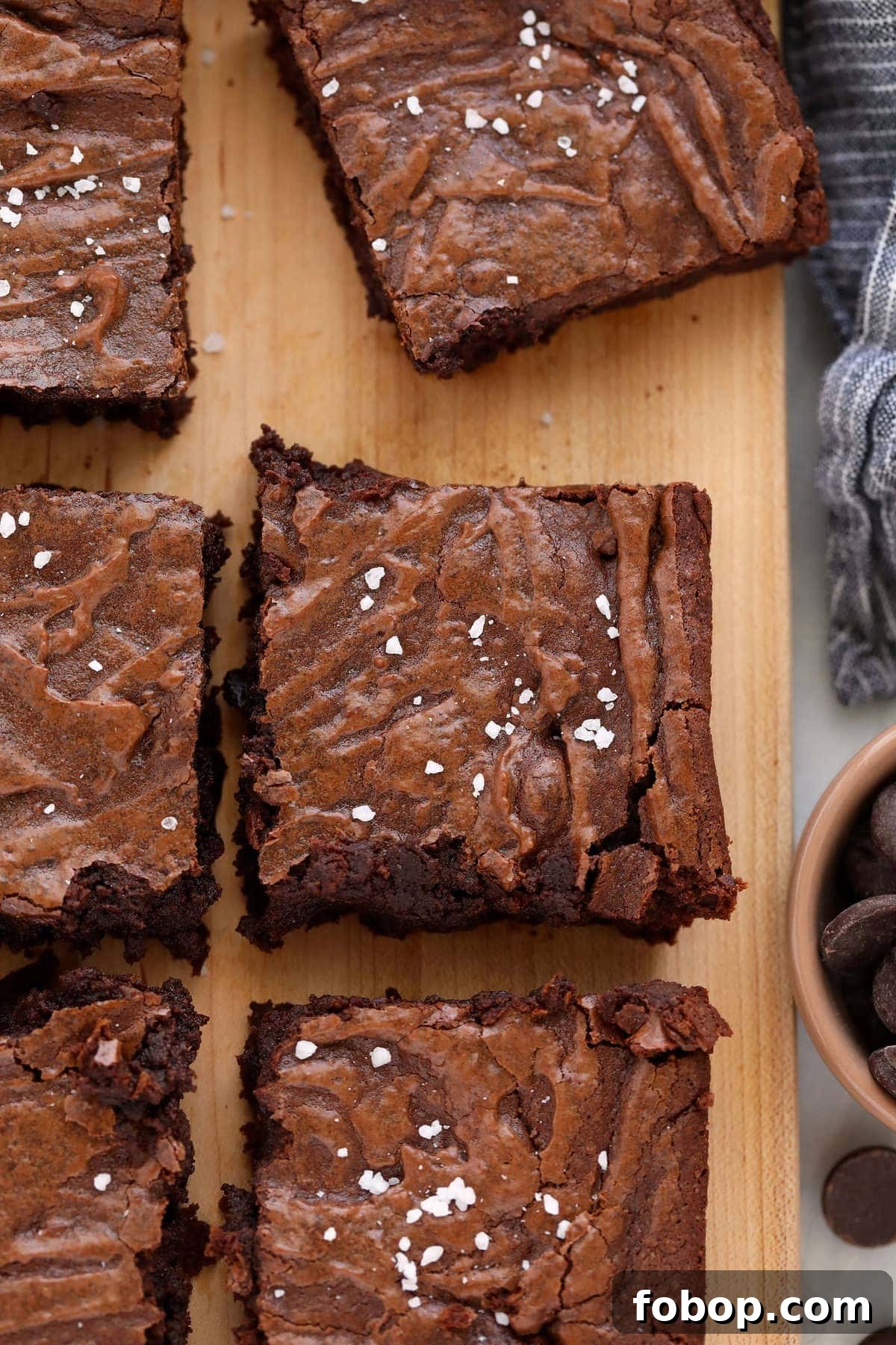 Get ready for the most delicious and simple fudgy brownie recipe you've ever had. These fudgy brownies are made with 7 ingredients and in less than an hour! fudgy brownies on cutting board