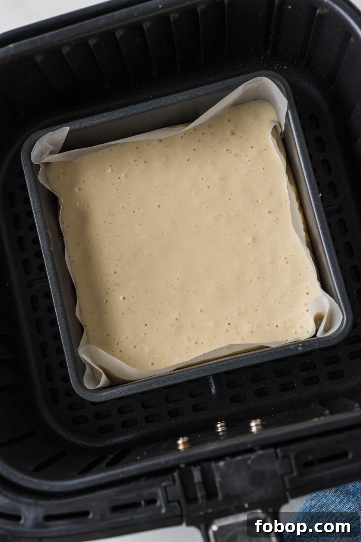 batter in a baking pan in the air fryer.