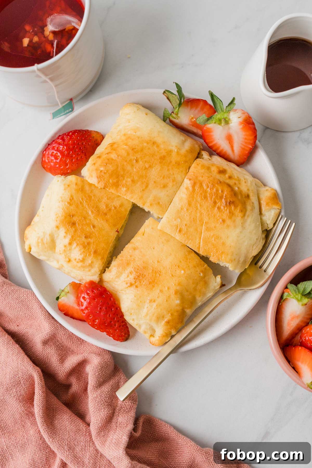 pancake cut into squares on a plate with strawberries.