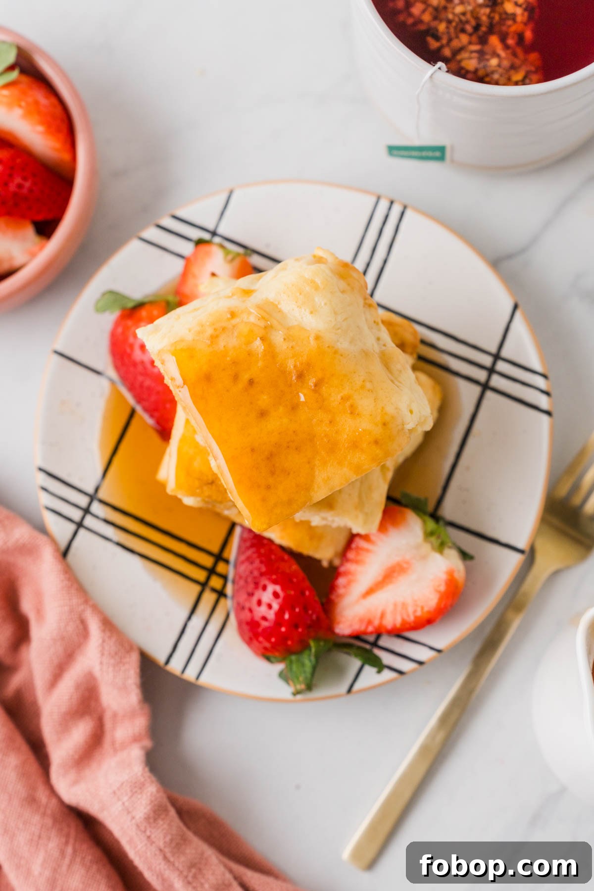 pancakes with syrup and strawberries.