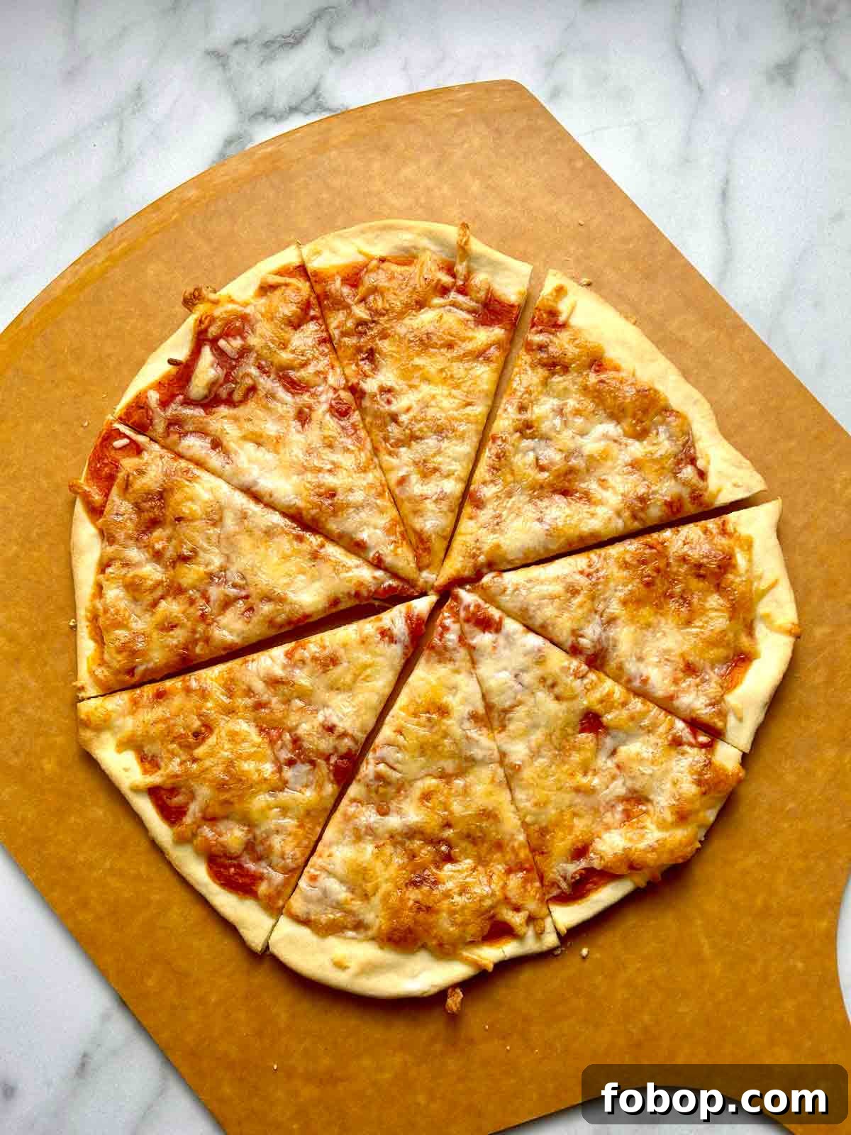 Crispy Cracker-Crust Pizza Recipe: Thin, Crunchy Homemade Pie 2 overhead shot of pizza cut into slices