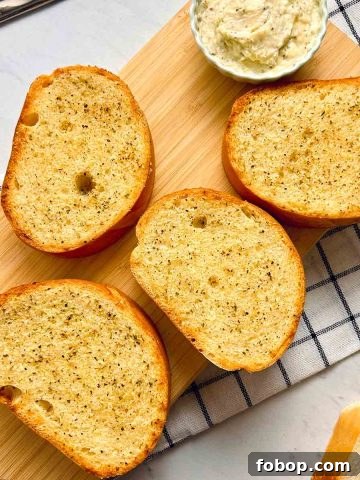 slices of garlic bread on wooden cutting board