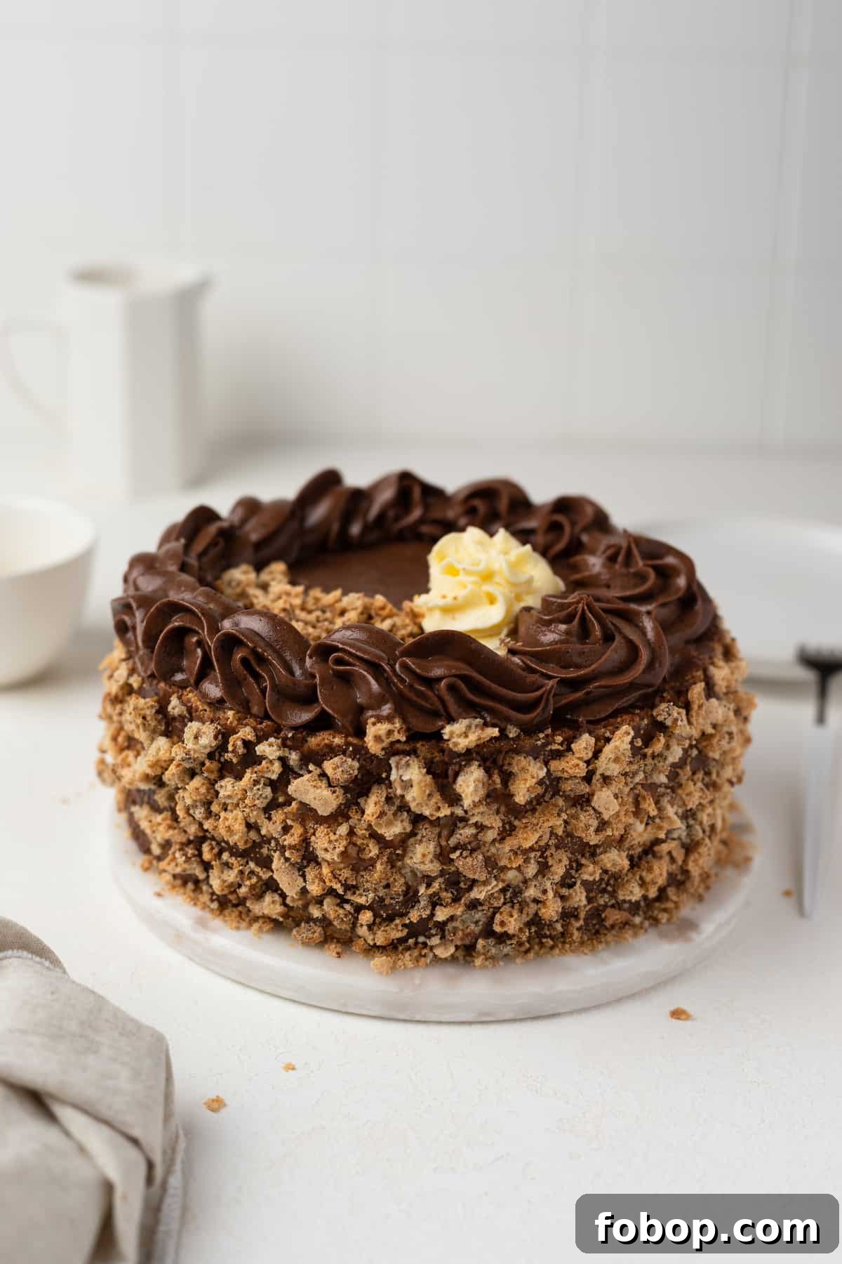 Classic Kyiv Cake Recipe: Authentic Ukrainian Hazelnut Meringue Cake 3 Decorated Kyiv cake on a cake board.