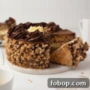 Classic Kyiv Cake Recipe: Authentic Ukrainian Hazelnut Meringue Cake 4 Sliced Kiev cake on a dessert board.