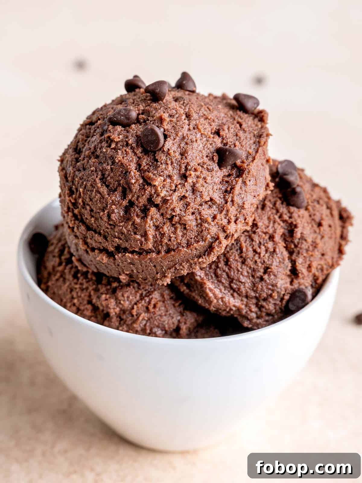 Homemade Edible Chocolate Cookie Dough Recipe 2 Scoops of chocolate cookie dough in a bowl.
