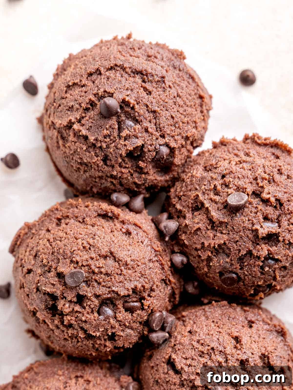 Homemade Edible Chocolate Cookie Dough Recipe 5 Scoops of chocolate cookie dough on parchment paper.