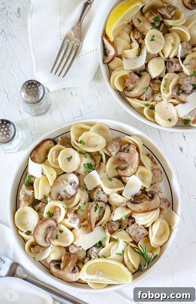 Creamy Pasta alla Norcina with Homemade Italian Sausage 2 Creamy pasta with homemade sausage served in two bowls on white background.