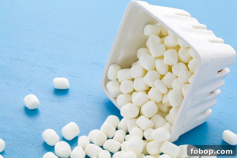 Soothe a Sore Throat with Marshmallows: Gentle Home Remedies 6 Small round white marshmallows on blue background.