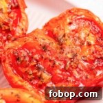 Air fryer tomatoes on a white plate.