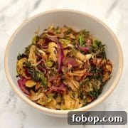 Cruciferous Crunch braised with garlic, olive oil and vinegar in a white bowl.