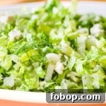 Closeup side view shot of Prasini salad in a white dish.