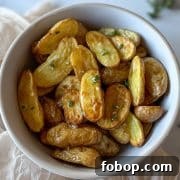 Air Fryer roasted fingerling potatoes dressed in olive oil, lemon juice, garlic, and thyme dressing.