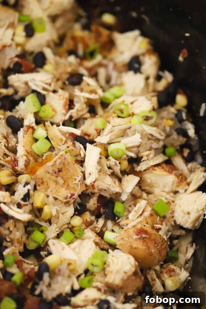 Slow Cooker Chicken Burrito Bowls Recipe for Weeknight Meals 2 slow cooker chicken burrito bowl made with corn, beans, green onions and crockpot chicken. Slow cooker burrito bowl.