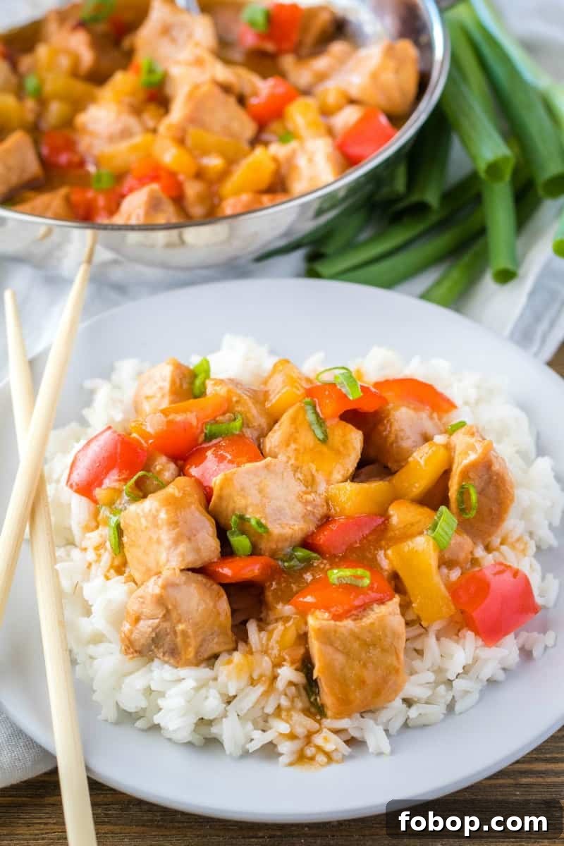 Slow Cooker Sweet and Sour Pork Recipe for Tender, Saucy Pork 2 sweet and sour pork served over rice with chopsticks