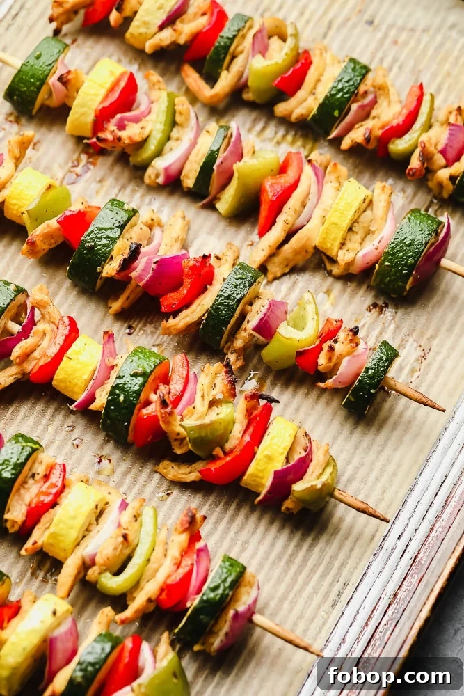 Grilled Vegan Kebab Recipes for Flavorful Plant-Based Meals 5 cooked vegetable kebabs on a parchment lined baking sheet