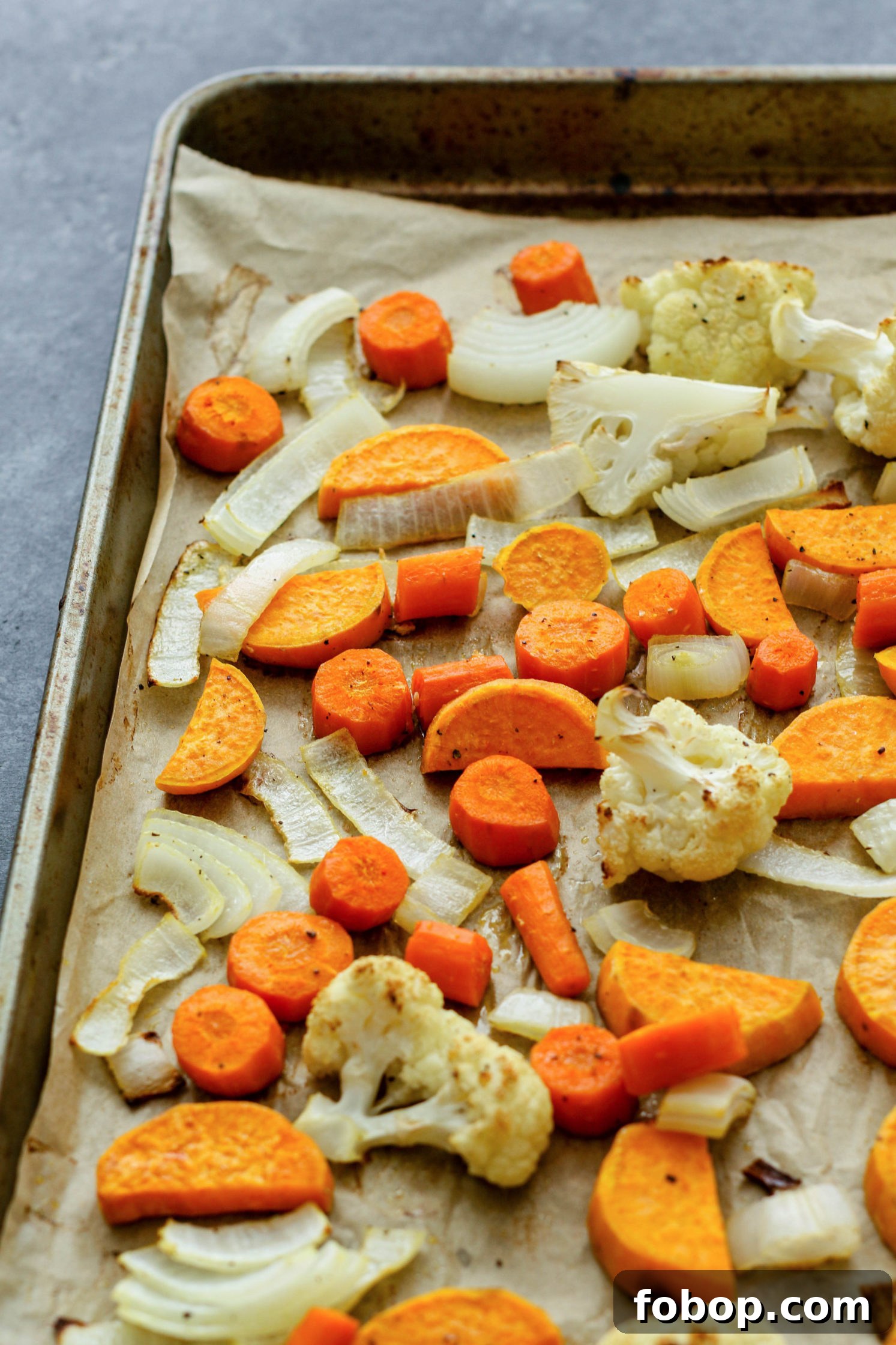 Roasted Pumpkin and Autumn Vegetable Soup Recipe 3 roasted vegetables on parchment lined baking sheet