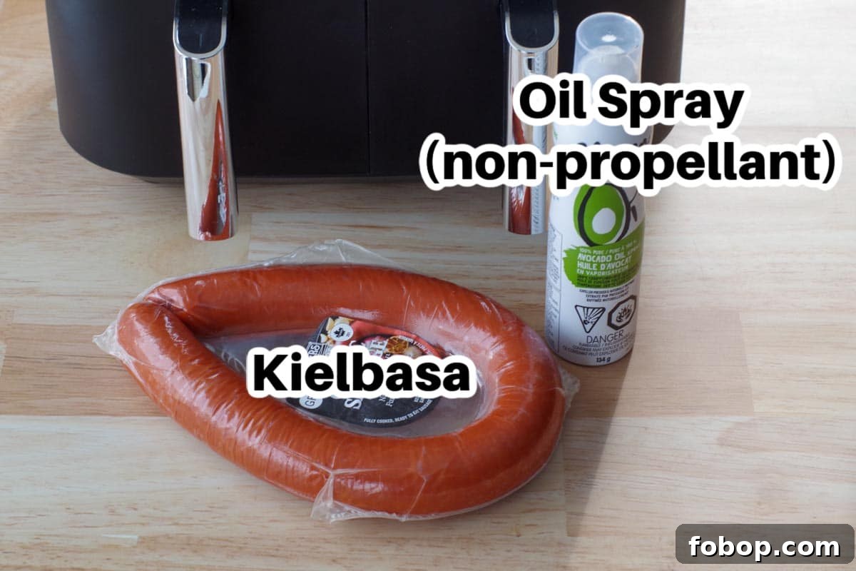 kielbasa and spray oil on counter surface with air fryer in the background