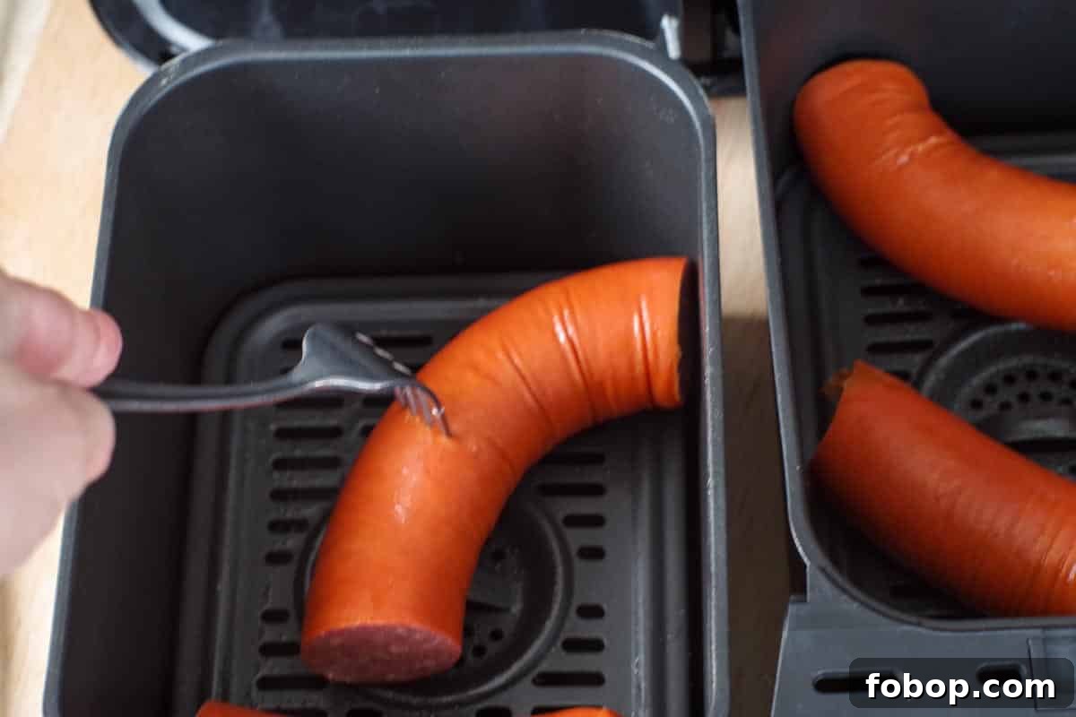 kielbasa being poked with a fork