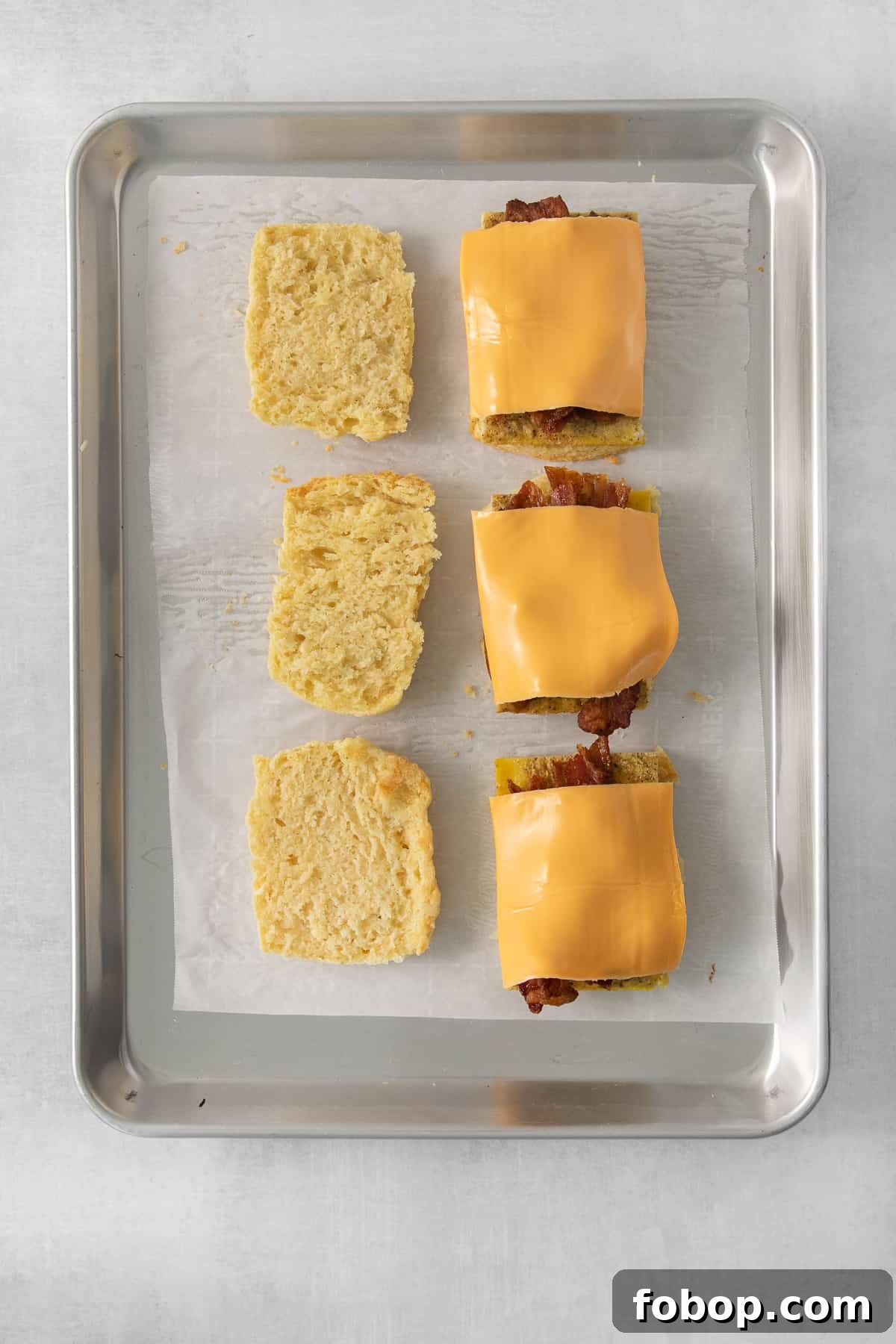 How to Make a Copycat Bacon Egg and Cheese Sandwich Recipe 8 cheesy tater tots on a baking sheet.