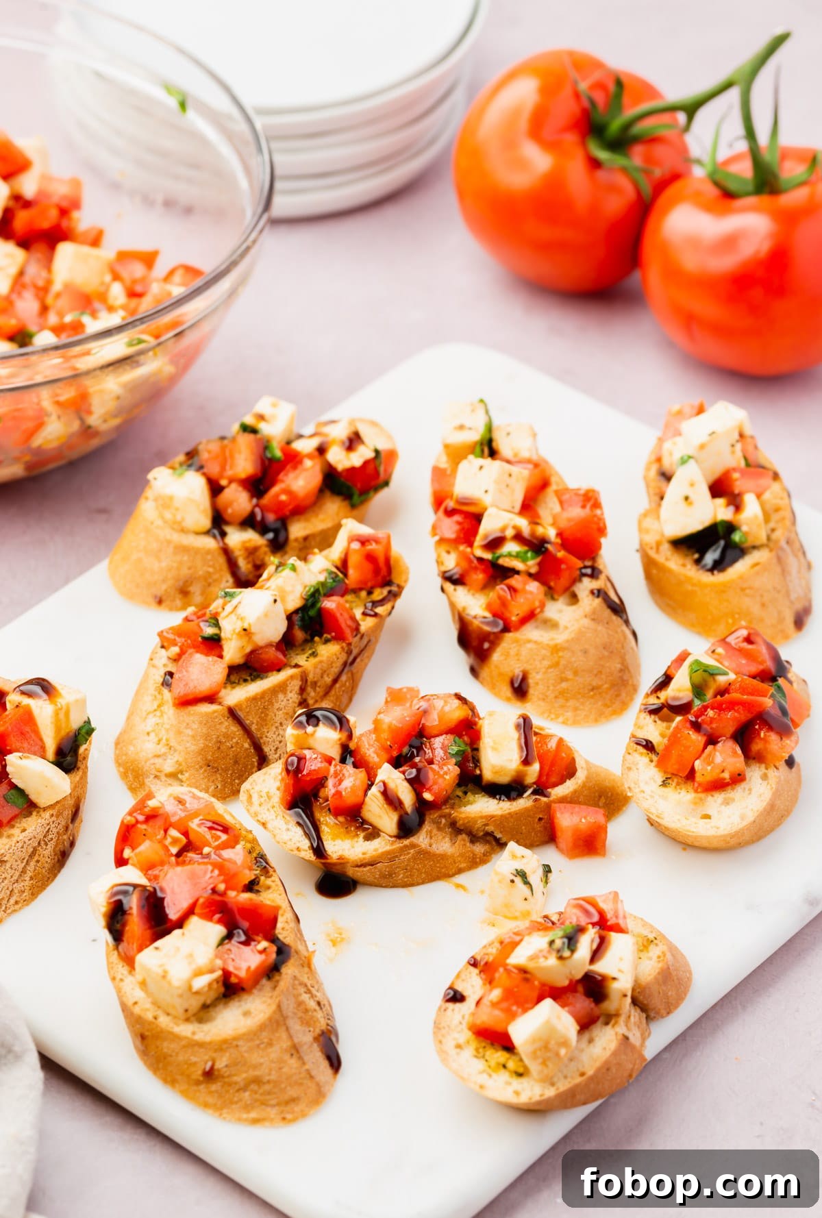 A plate full of gluten-free bruschetta with a mozzarella tomato caprese mixture topping.