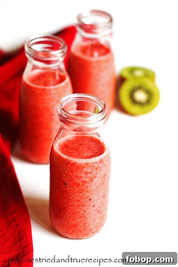 Smoothie in three glasses with sliced kiwi and a red napkin next the the glasses