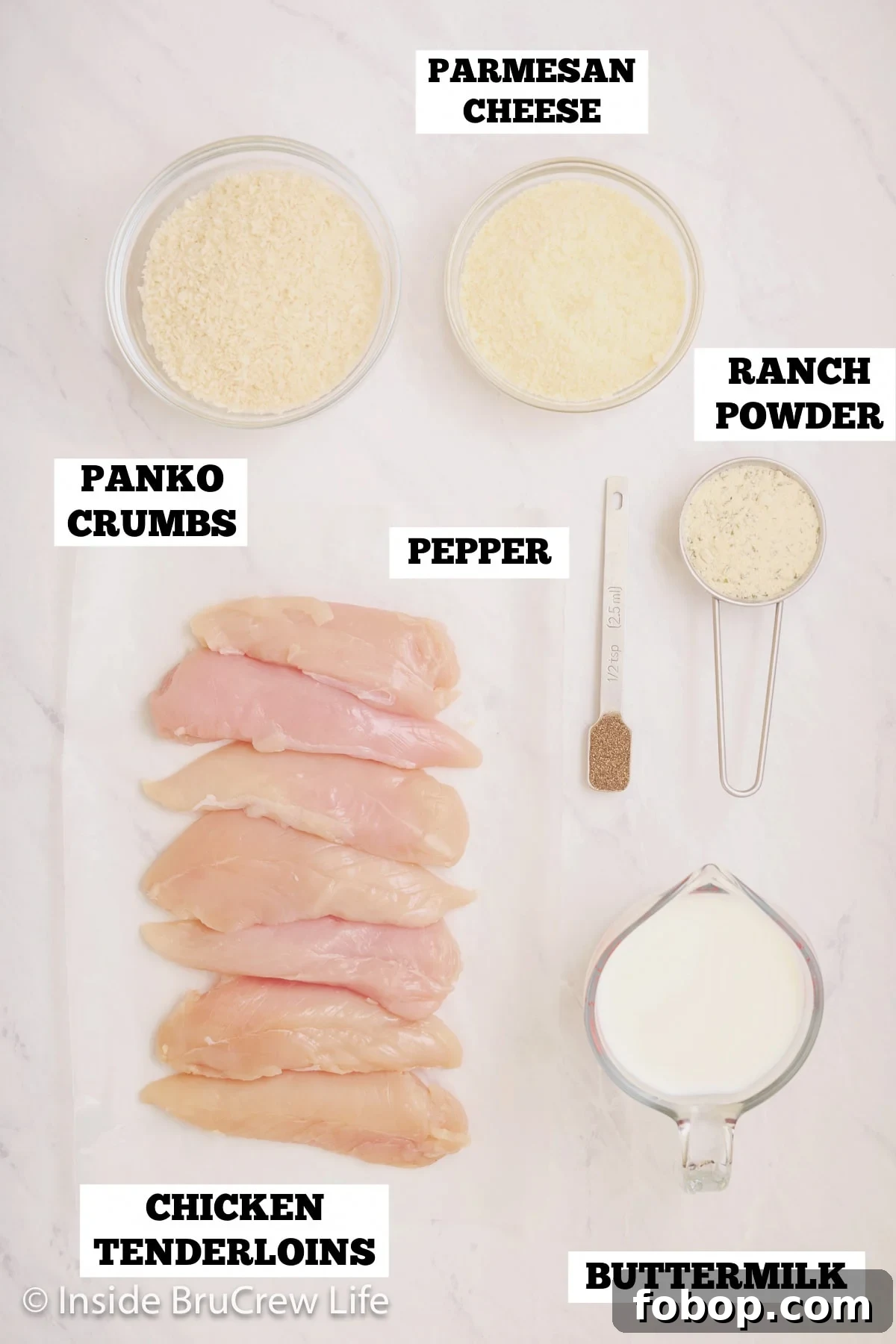 Crispy Parmesan Chicken Tenders with Garlic Herb Dipping Sauce 3 A white board with ingredients needed to make baked chicken strips on it.
