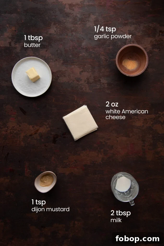 Everything you need to make the cheese sauce for a vegetarian Philly Cheesesteak including white American cheese, milk, Dijon mustard, butter, and garlic powder.