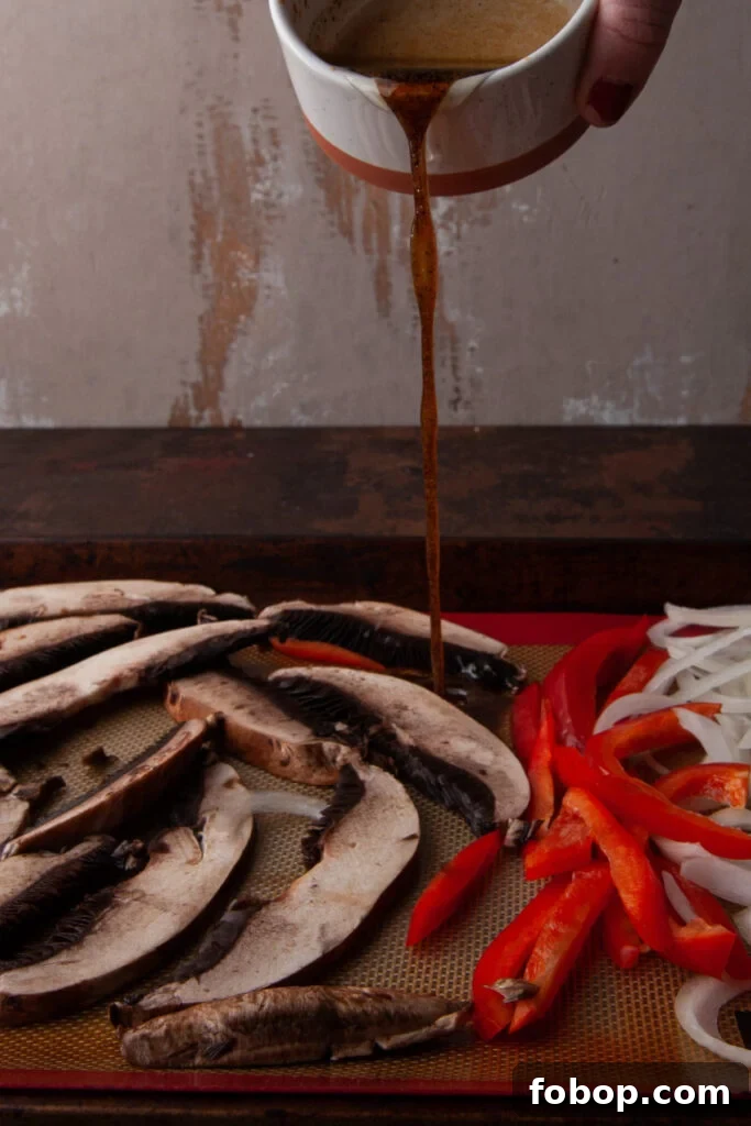 Pouring quick marinate over sliced vegetables to replace steak in a vegetarian version of a Philly Cheesesteak.