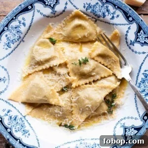 A cropped image of triangoli pasta in a blue patterned bowl.