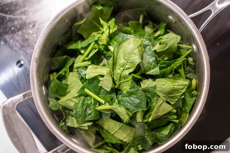 Adding the spinach to the pot