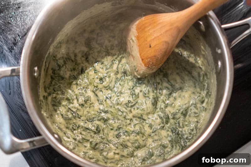 Simmering the creamed spinach