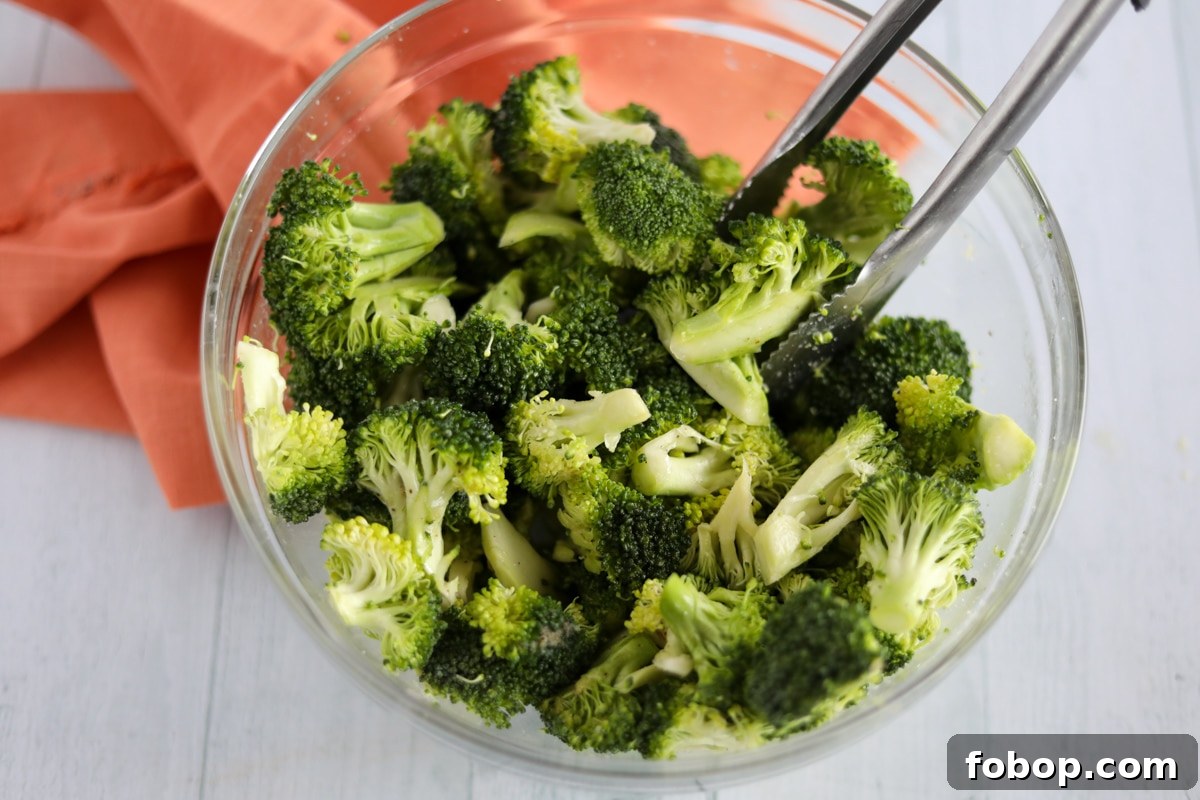 Crispy Garlic Lemon Air Fryer Broccoli Recipe 4 washed broccoli florets in clear mixing bowl