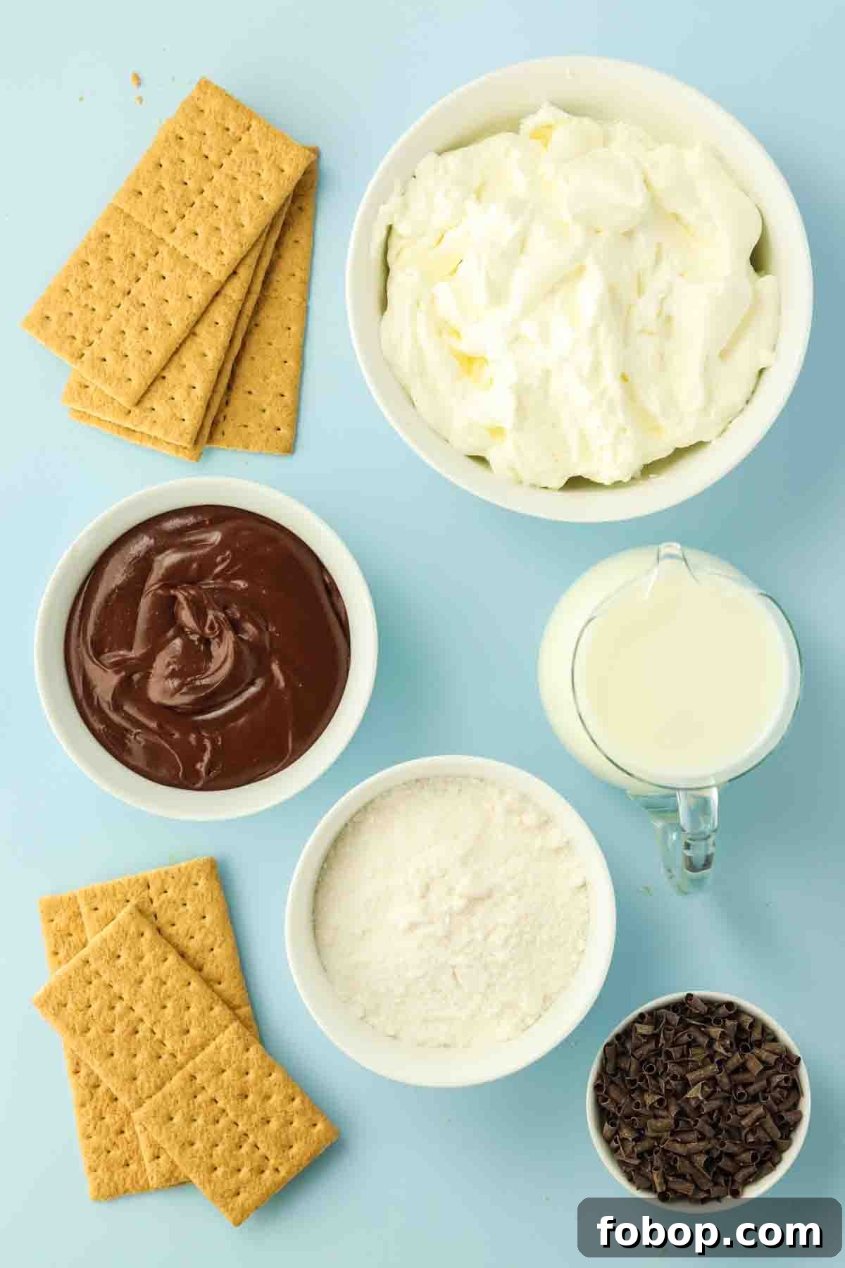 No-Bake Chocolate Eclair Cake Recipe (No Oven Needed) 3 Ingredients for no-bake chocolate eclair cake including graham crackers, pudding mix, milk, whipped topping, and chocolate frosting, chocolate curls