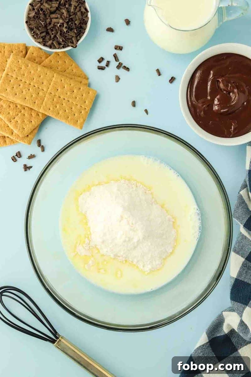No-Bake Chocolate Eclair Cake Recipe (No Oven Needed) 4 Adding instant vanilla pudding mix with milk in a large mixing bowl - Hostess At Heart