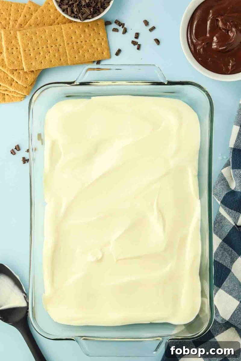 No-Bake Chocolate Eclair Cake Recipe (No Oven Needed) 7 A creamy vanilla pudding mixture layered over graham crackers - Hostess At Heart
